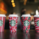 Four new Starbucks 2021 holiday cups with red festive designs